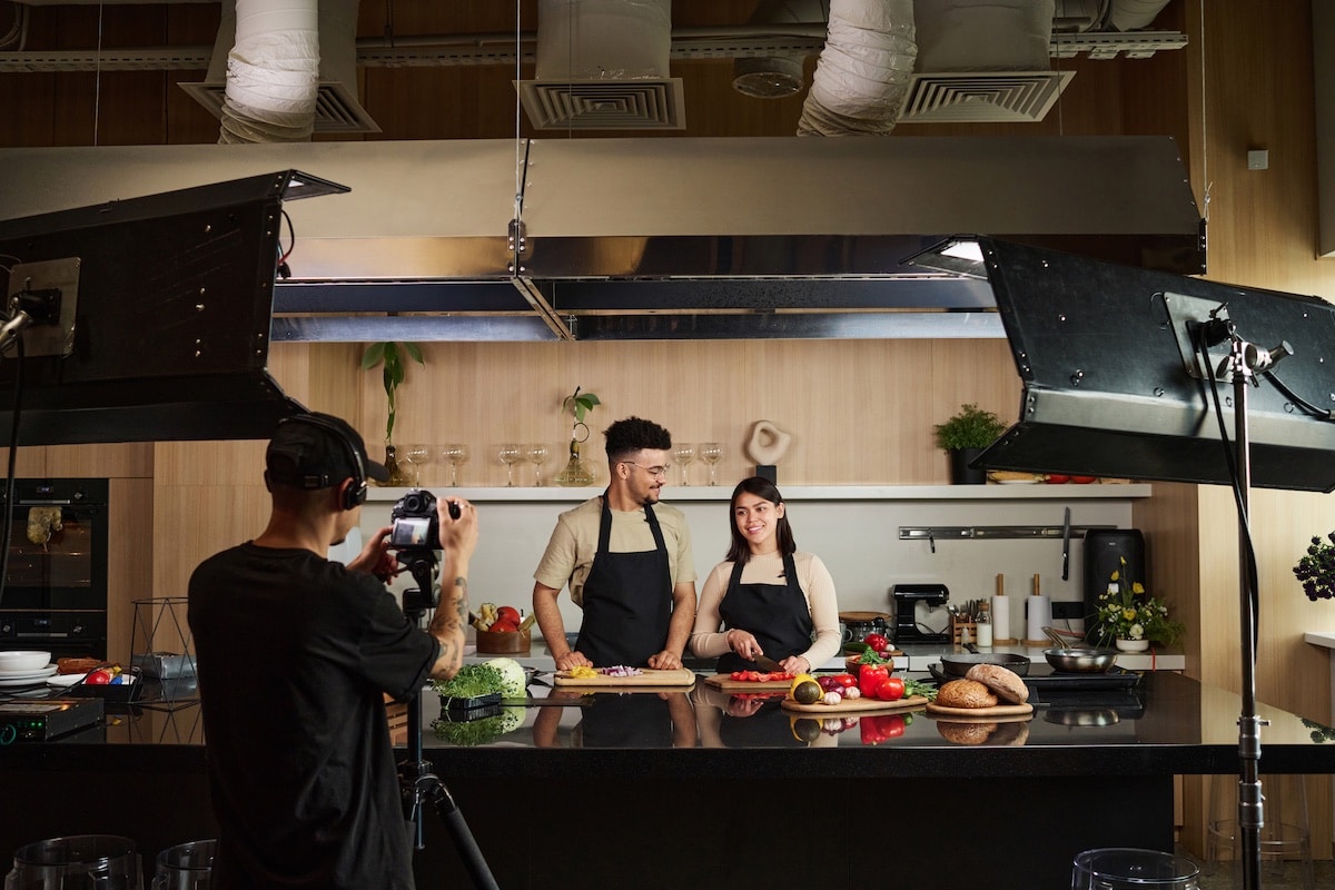 Food Bloggers Filming on Professional Set Production crew filming corporate video for culinary business