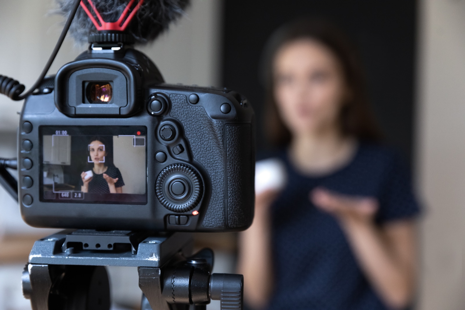 how to make a promotional video Woman behind the camera with product making a promotional video</p>
<p>