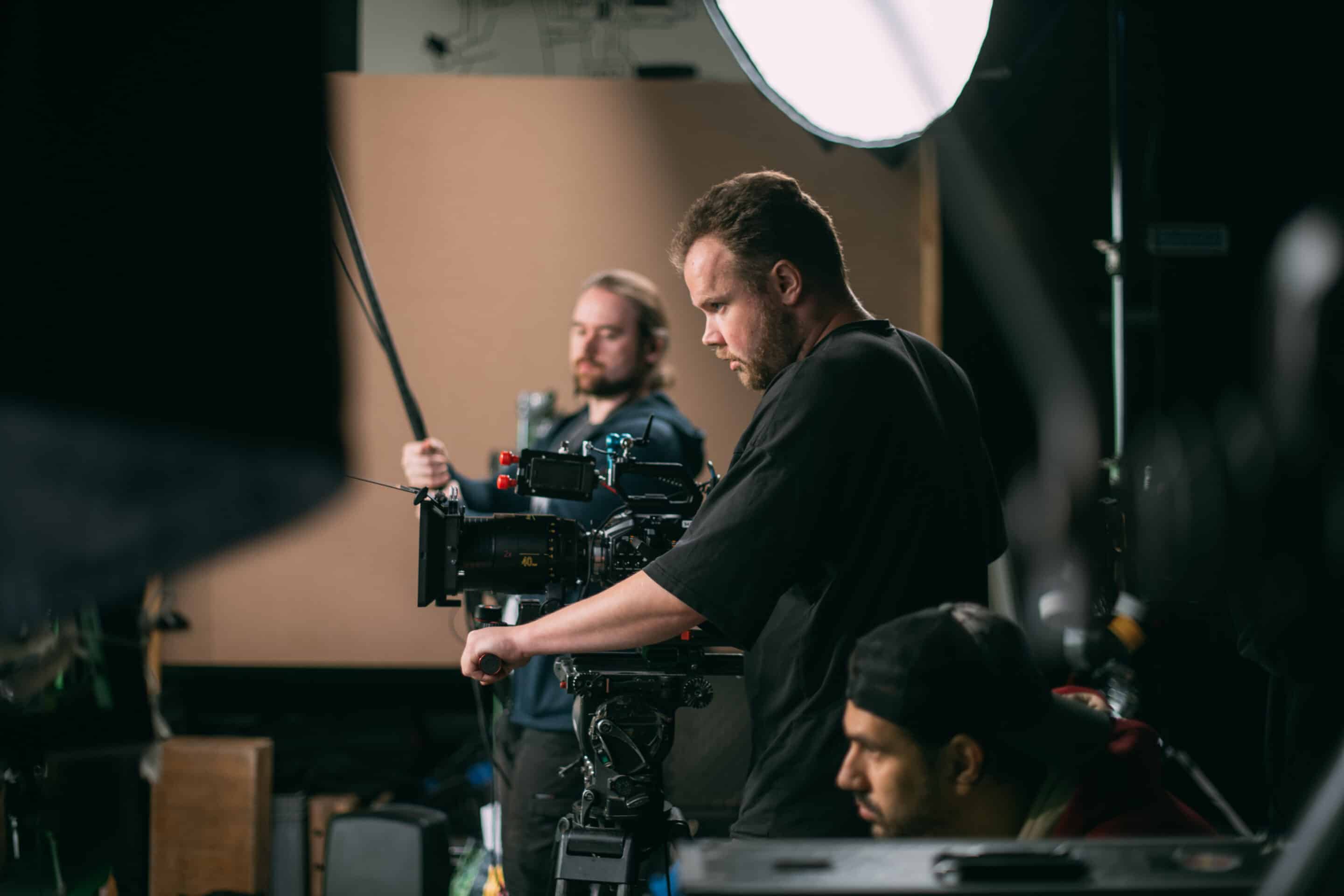 A professional video production team in the process of filming a video.</p>
<p>