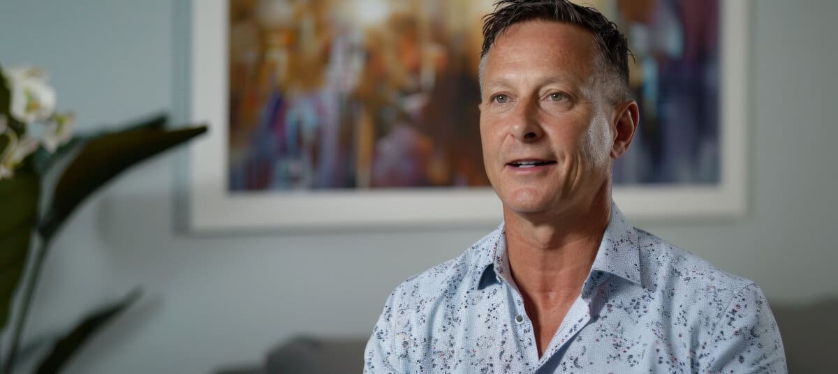 Man providing testimonial to camera