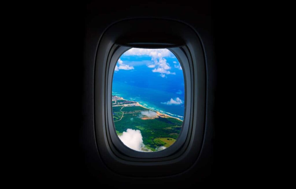 location scout's view out of airplane window overlooking island