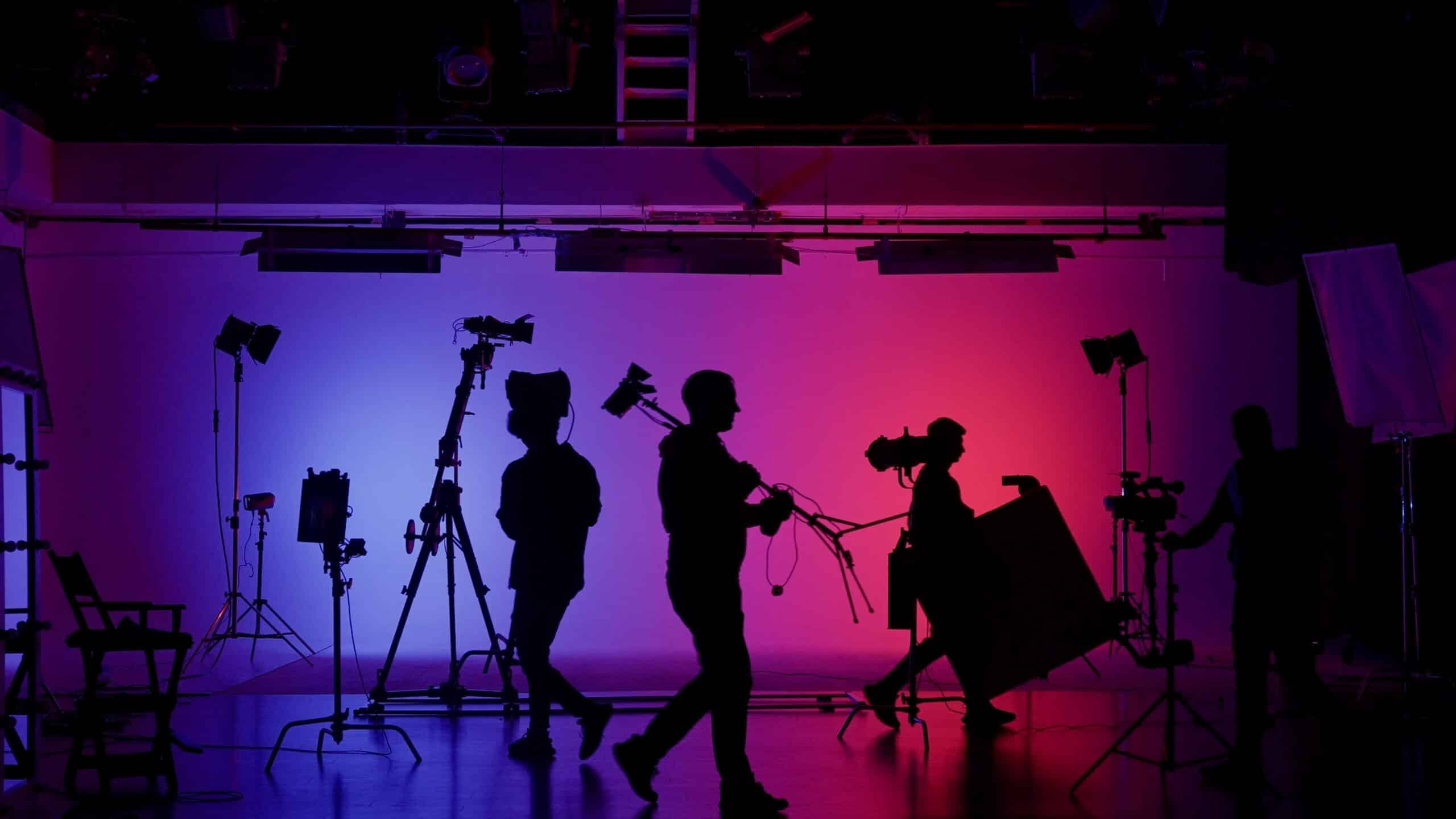 Film production crew setting up cameras and lighting for a music video